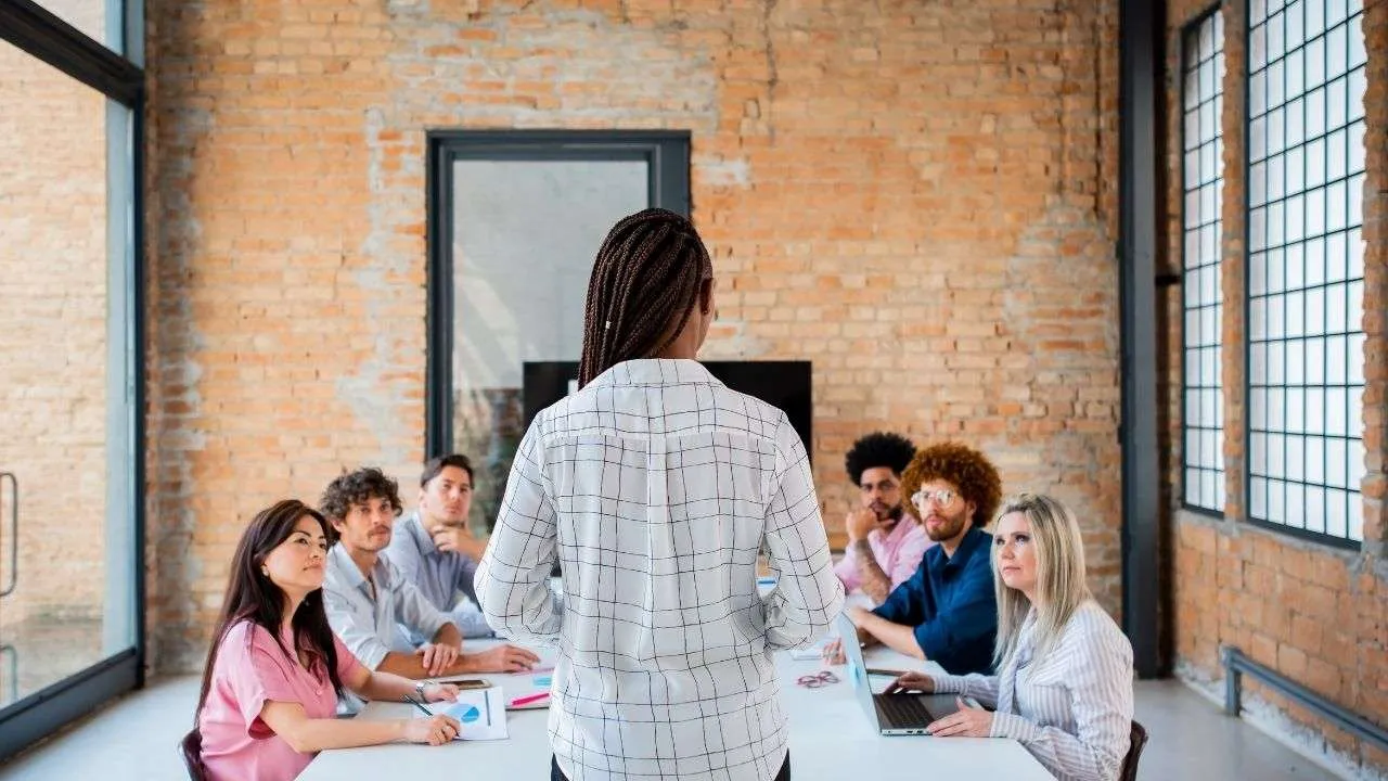 Woman presenting to colleagues in an office